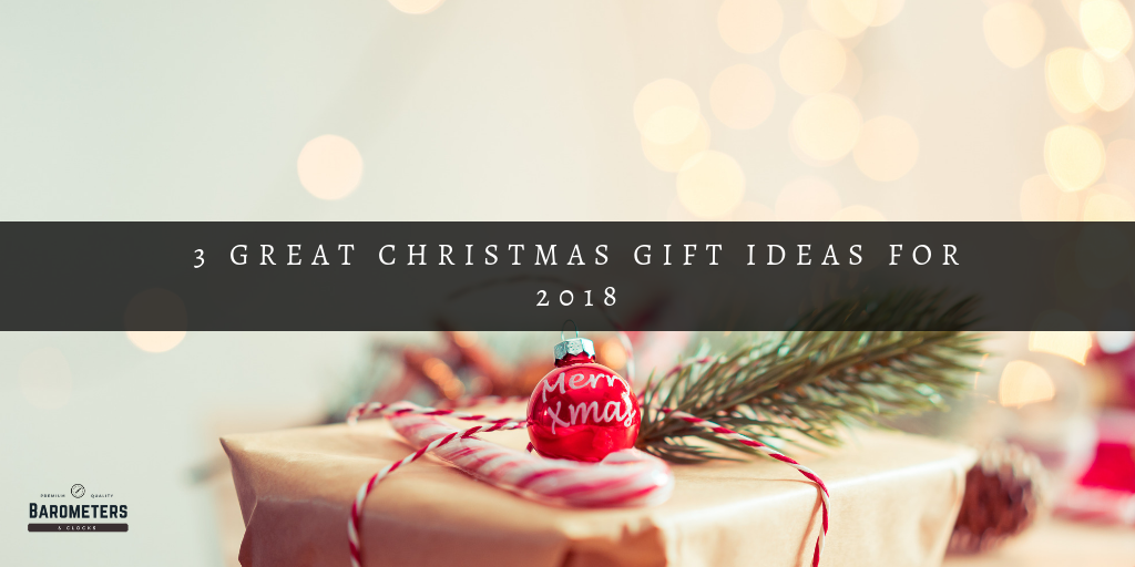 Christmas gift box with a red ornament and pine branch, festive holiday background