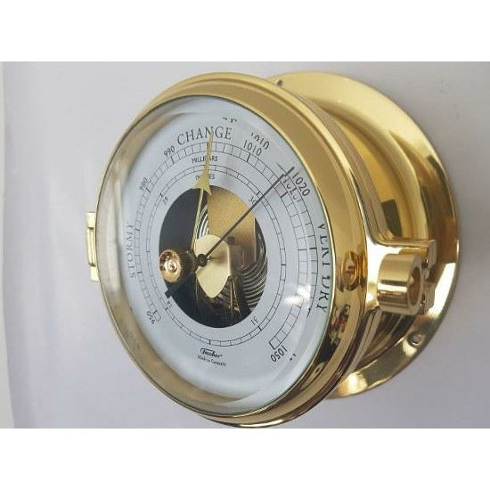Brass wall-mounted barometer with analog dial for measuring atmospheric pressure
