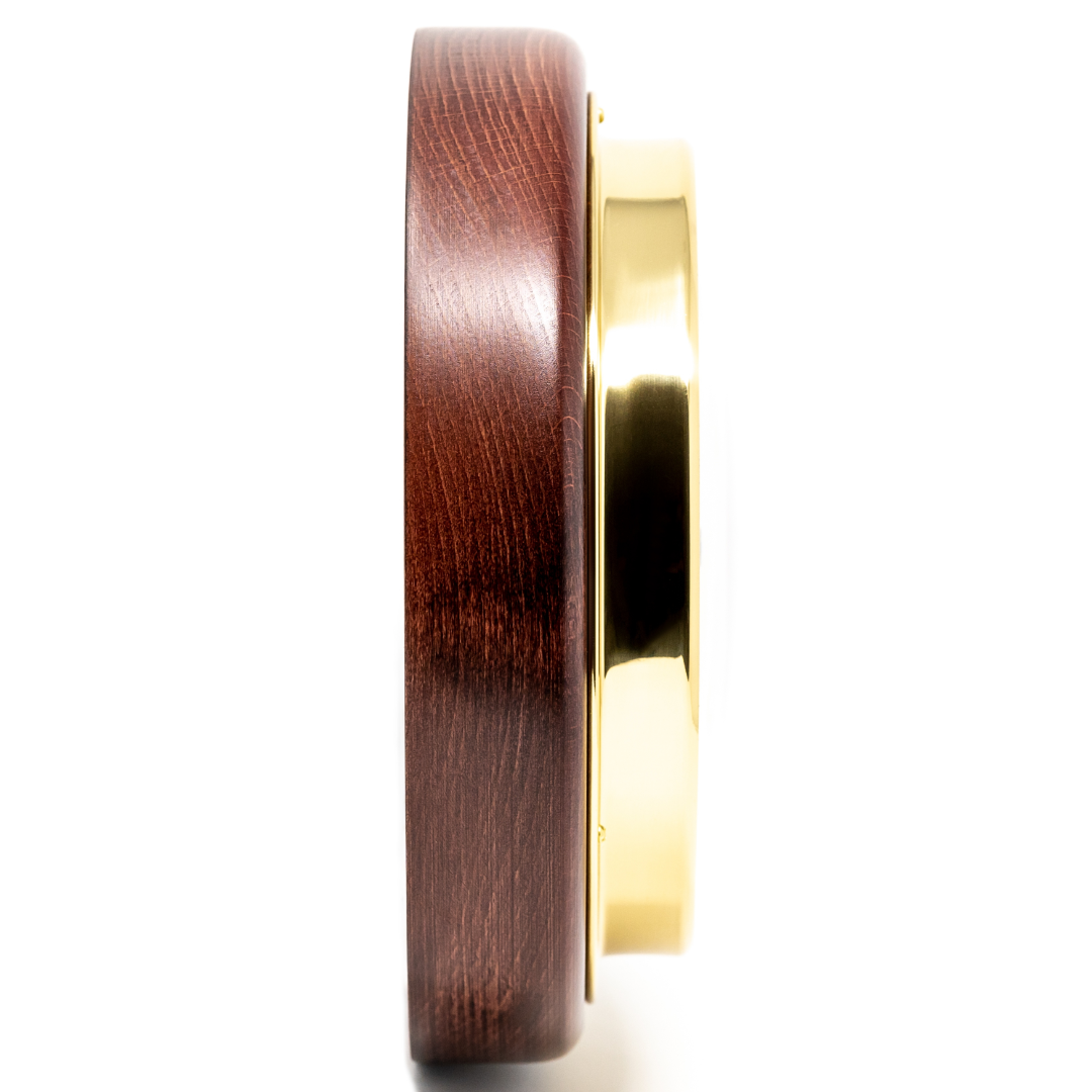 Side view of nautical barometer with gold bezel and polished wood frame