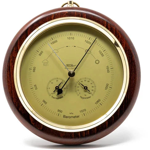 Wooden wall-mounted analog barometer with thermometer and hygrometer display.