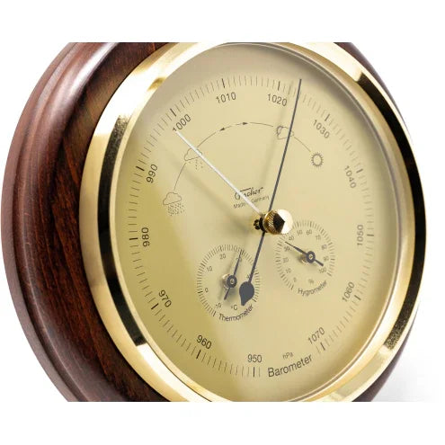 Analog barometer with gold trim and wooden frame, featuring thermometer and hygrometer dials