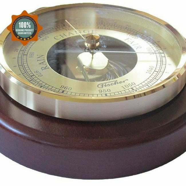 Analog barometer with gold dial and wooden base, measuring air pressure for weather.