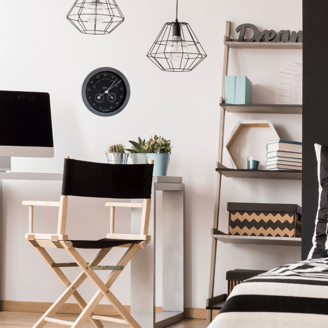 Modern home office with a wall-mounted black barometer and hygrometer above desk