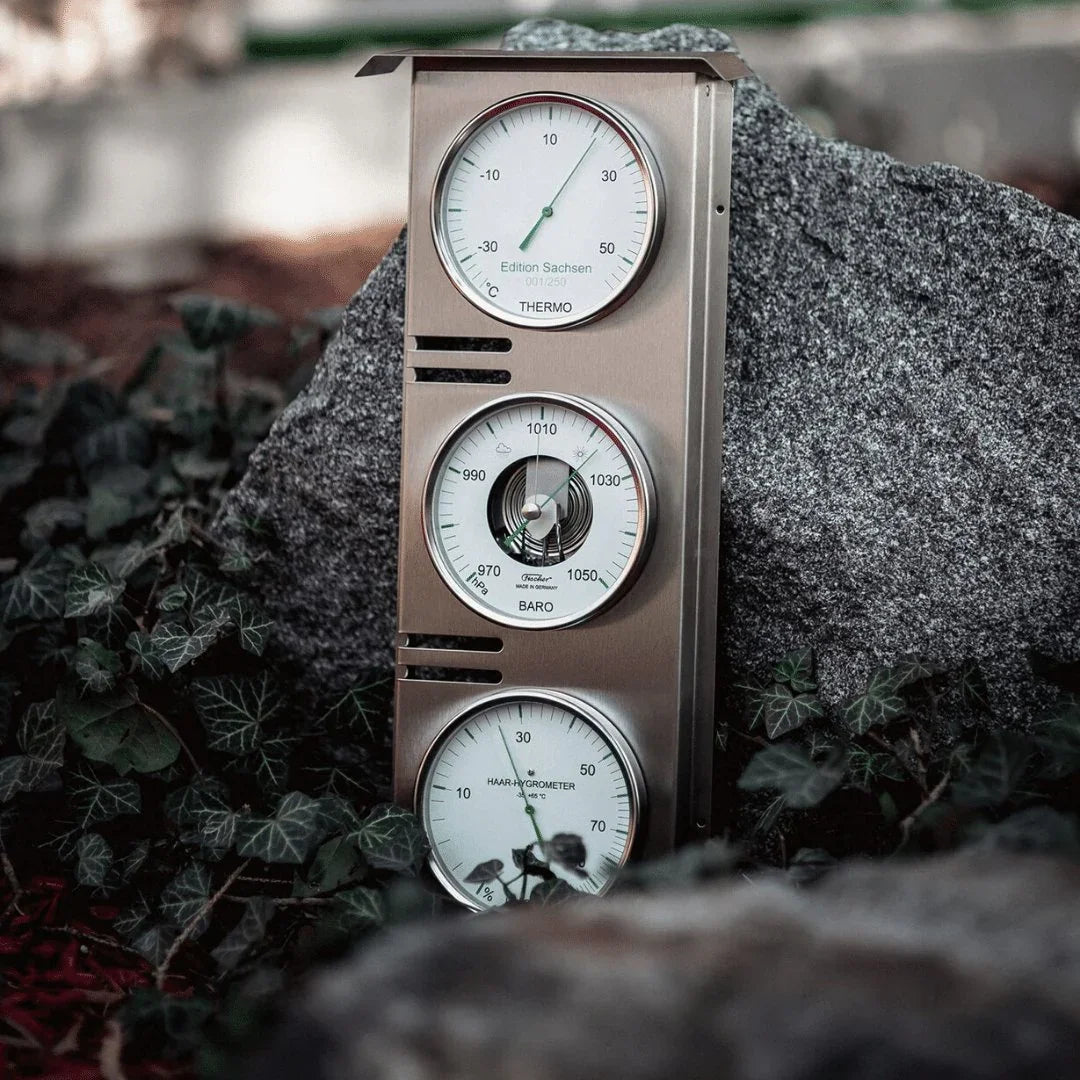 German made weather station with barometer, thermometer, and hygrometer set on outdoor rock