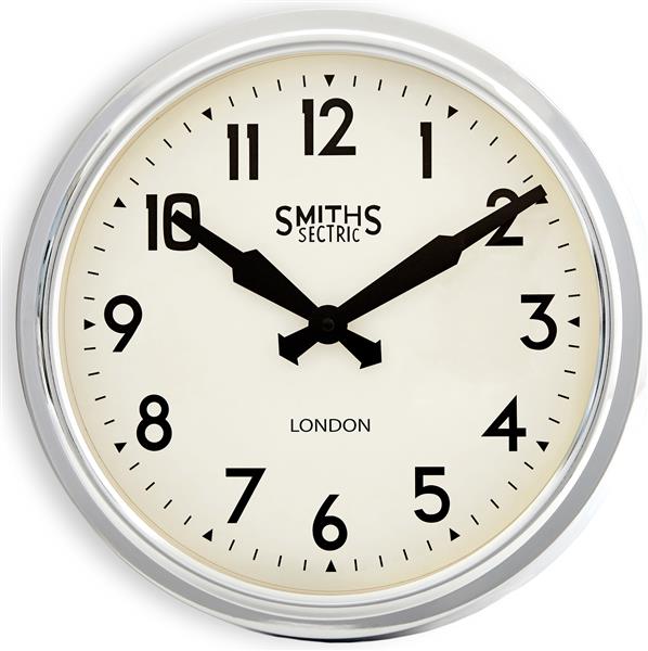 Classic wall clock with white face, black numbers and hands, chrome frame, indoor setting